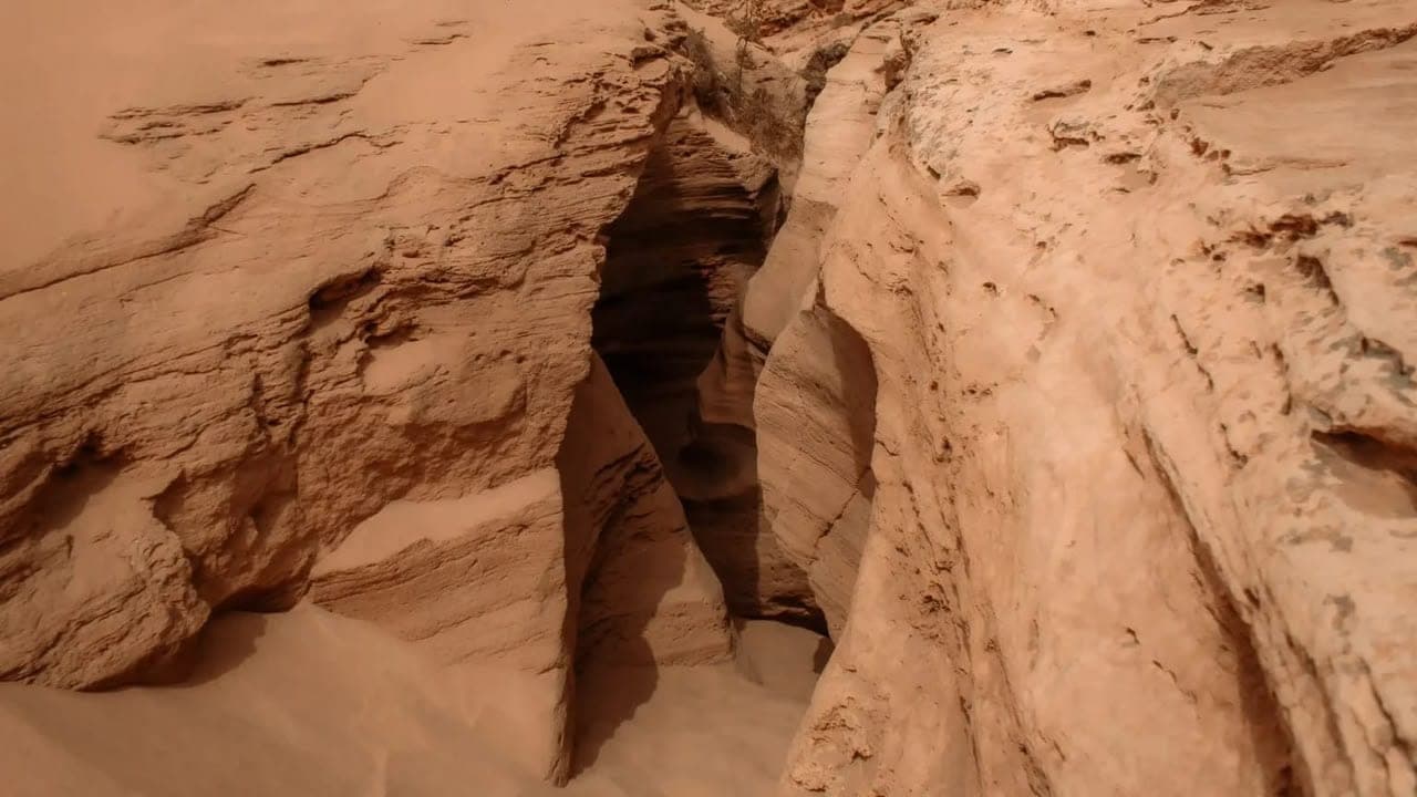 Narrow sandstone canyon at Timlalin seen from above, with sand at its base